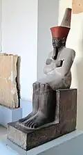 An Osiride statue of the first pharaoh of the Middle Kingdom, Mentuhotep&nbsp;II; 2061–2010&nbsp;BC; painted sandstone; 138 × 47&nbsp;cm; Egyptian Museum (Cairo)