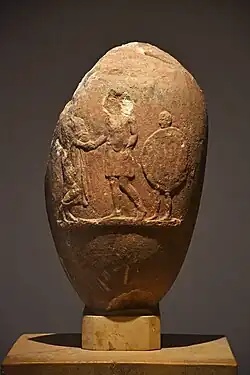 Hoplite greeting an older man with slave carrying the aspis