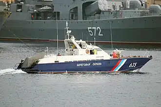 The Russian Coast Guard Sobol-class patrol boat PSKA-310 underway and the Russian Navy destroyer Admiral Vinogradov (background) in Zolotoy Rog Bay at Vladivostok, 2014