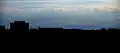 Mount Parashka (in the middle) in the background of the building of the State Tax Service. View from Lviv (90 km)