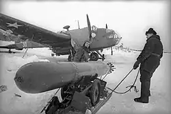 Weapons technicians preparing a&nbsp;18-inch (450&nbsp;mm) torpedo for arming a&nbsp;Handley Page Hampden TB Mk&nbsp;I torpedo bomber of the Northern Fleet Air Force 24th Mine-Torpedo Aviation Regiment—a&nbsp;former aircraft of No.&nbsp;144 Squadron RAF or No.&nbsp;455 Squadron RAAF—that was donated to the Soviet Union after Operation Orator; late 1942 and early 1943