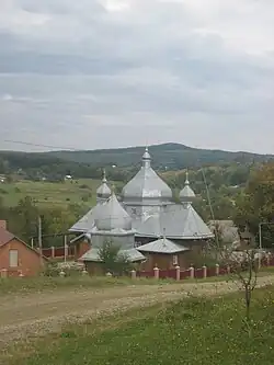 A wooden church with a metal roof