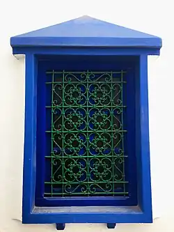 Image 15A window displaying a wrought iron window grill in Asila. The knots are tied with bent metal in the traditional way, rather than soldered. (from Culture of Morocco)
