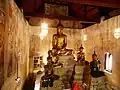 The principal Buddha image and smaller statues inside the hall