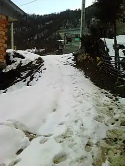 A snow-covered street in the village of Mahian