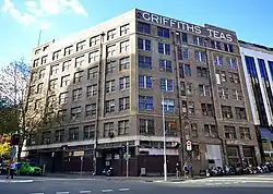 Griffiths Teas building in Sydney, view from the intersection of Wentworth Ave (left) and Hunt St (right). The facades facing these streets form an obtuse angle, May 2014
