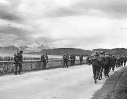 Members of the 86th Infantry Regiment, 10th Mountain Division, march north, near Malcesine, on Lake Garda, April 29, 1945.