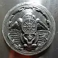 Seal of Chai Nat Province (a garuda upholding the dhammacakka in front of the mountain and river), Wat Sri Suphan, Chiang Mai, Thailand.