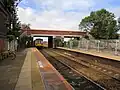 A Northern Rail Class 142 departs towards Liverpool. Engineering work for the reinstatment of platforms is visible.