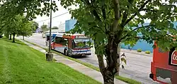 A gray, red and blue bus