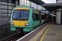 A train waiting at a built-up station platform