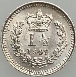 Silver coin with a number in a wreath