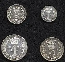 Silver coins with a number in a wreath