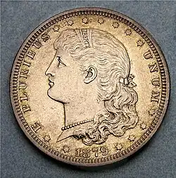 Left-facing bust of Liberty as a young girl wearing a headband and bow in her hair. Text reads E PLURIBUS UNUM / LIBERTY /1879