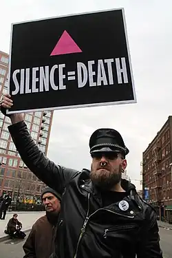 ACT UP sign with an upward-pointing pink&nbsp;triangle (2017)