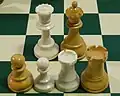1950 Dubrovnik pawns, rooks, and queens with Staunton pieces side by side (clockwise from top left: Staunton queen, Dubrovnik queen, Dubrovnik rook, Staunton rook, Staunton pawn, Dubrovnik pawn)