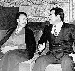 Two men in conversation on a sofa