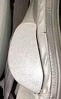 Early-style two-piece armrest extension on a DeLorean