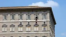 Image 5The Apostolic Palace (Palazzo Apostolico), the official residence of the pope. Here, Benedict XVI is at the window marked by a maroon banner hanging from the windowsill at centre. (from Vatican City)
