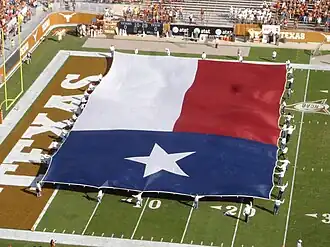 Large Texas flag at a football game.