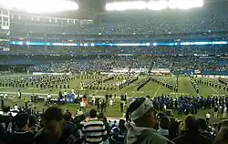 University of Connecticut marching band on the Rogers Centre field, in a formation spelling out U C O N N