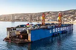 SOCIBER floating drydock, Valparaiso III with tugboat Pequen, being worked on in the cradle, in Valparaiso, Chile