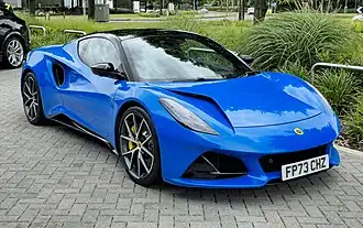 A two-door car with alloy wheels and large vents in the bonnet.