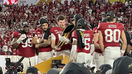 Players celebrate with a trophy.