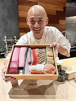 Chef shows fish.