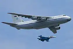 An An-124-100 accompanied by a Su-27UB