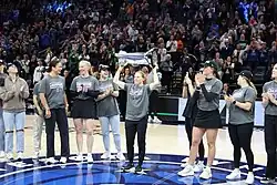 Coyne raises the Walter Cup at a Minnesota Lynx game, May 2025