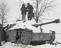 Engineers from the 291st disarm a booby-trapped Sturmgeschütz III during the Battle of the Bulge