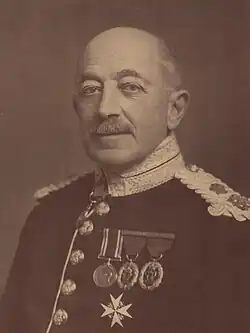 Cottesloe in older age; balding, wearing military dress uniform and medals.