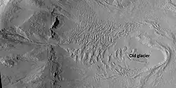 Glacier and gullies, as seen by HiRISE under HiWish program Some researchers suggest that gullies come after glaciers. Location is Casius quadrangle.
