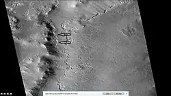 Wide view of part of Milankovic Crater, as seen by HiRISE under HiWish program. Arrows indicate places where ice is near surface.[81]