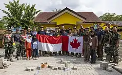 U.S. Army engineers, Canadian Armed Forces engineers, and Indonesian National Armed Forces engineers pose for a group photo with local children during the Engineer Civic Action Program project during exercise Super Garuda Shield 2025 in Baturaja, Indonesia, 25 August 2025.
