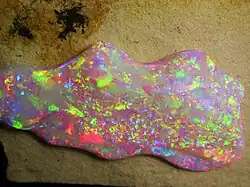Brazilian Crystal Opal. The play of color is caused by the interference and diffraction of light between silica spheres (150–300&nbsp;nm in diameter).