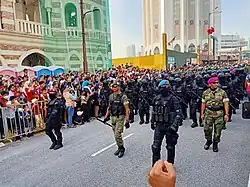 A joint special forces contingent from all three branches of the Malaysian Armed Forces marching during the 65th Merdeka Day parade. The commandos are showcasing various variations of their tactical combat uniforms, which differ according to mission and operational requirements.