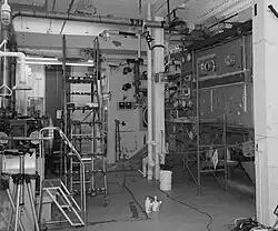 A black-and-white photograph of a room with a lot of industrial machinery