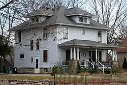 Image 9A wood-frame American Foursquare house in Minnesota with dormer windows on each side and a large front porch