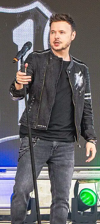 Brennan performing as part of 911 at Durham Pride UK on 25 May 2025