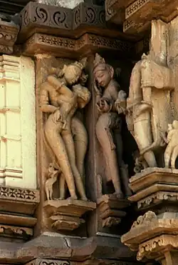 Apsara (right) exposes her yoni