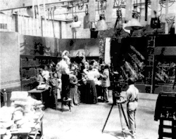 Image 3A.E. Smith filming The Bargain Fiend in the Vitagraph Studios in 1907. Arc floodlights hang overhead. (from History of film)