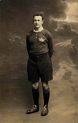 full body shot of Johnnie Wallace wearing his playing strip and boots