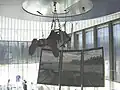 A visitor is suspended from the ceiling to navigate in a virtual reality.