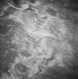 High-albedo swirls within unnamed crater east of Firsov