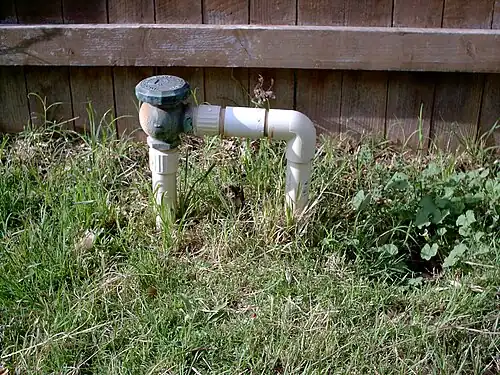 One-inch brass atmospheric vacuum breaker mounted on PVC Pipe