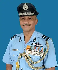 A color photograph, from the waist up, of a mustached man in air force uniform