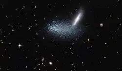 Irregular dwarf galaxy PGC 16389 covers its neighboring galaxy APMBGC 252+125-117.[27]