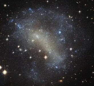 IC 4710 lies roughly 25 million light-years away in the southern constellation of Pavo.[20]